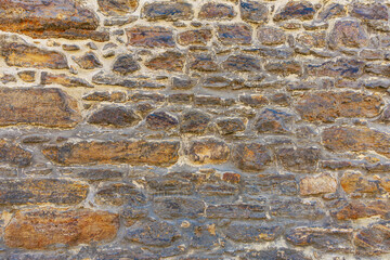 Textured stone wall with rough surface and natural earthy tones