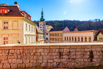 Scenic view of historic town square with stone wall and colorful buildings