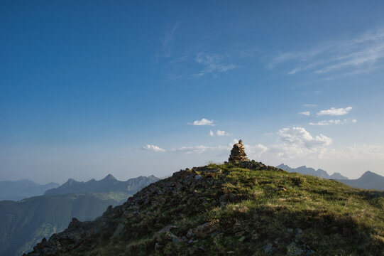 Stone men in the Swiss Alps in the canton of Uri with sun