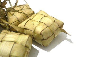 Traditional ketupat woven from young coconut leaves, commonly served during Eid al-Fitr and festive celebrations in Indonesia. Cultural food background.