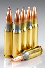 A close up of a rifle bullet with a row of cartridges in the background.