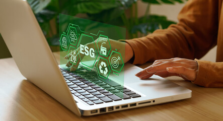 ESG concept icon Businessman using laptop with, focusing on sustainability strategy, environmental...