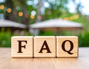 FAQ blocks on wooden table outdoors