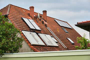 German roof with solar thermal, PV system and chimney ladder