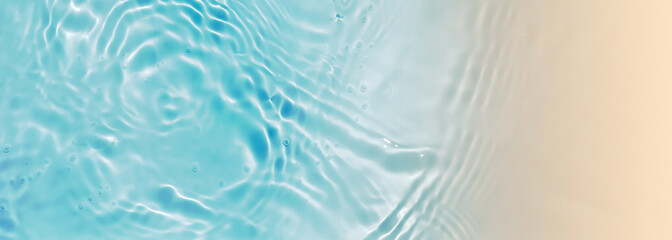 abstract blue water wave with sunlight reflection at sand beach from above, textured nature background banner concept with copy space for beach holiday, beauty spa travel and vacations