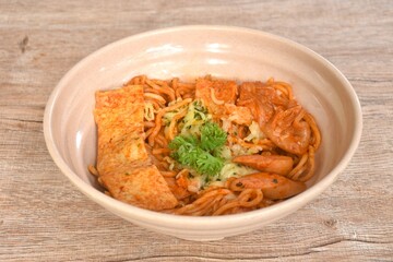 stir ramen Japanese noodles with slice pork sausage and tofu with cabbage in Korean kimchi sauce on bowl