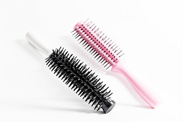 Round and vented hairbrushes on white background.