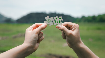 Hands Holding Puzzle Pieces Symbolizing Eco-Friendly Solutions