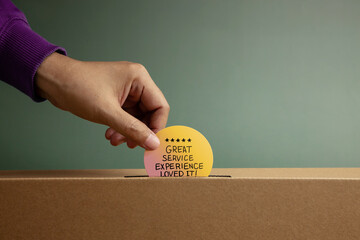 Hand putting Customer Service Experience Review card in box symbolizing Feedback, survey response, and constructive evaluation