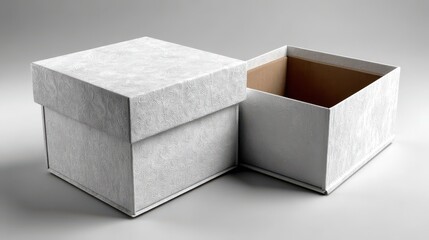 Two white embossed cardboard gift boxes