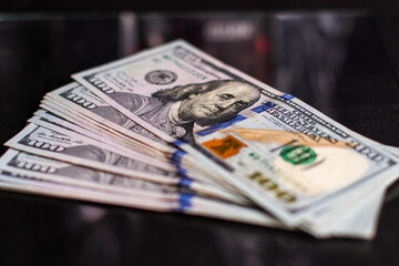 Stack of one hundred dollar bills close-up.
