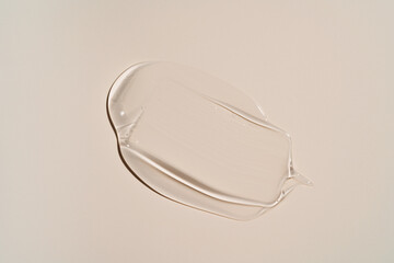 Close-up shot of beige liquid cosmetic gel or serum makeup swatches with a glossy, shiny texture on...
