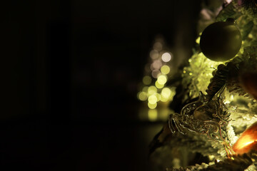 Close-up of Festive Christmas Tree Decorations with Golden Ornaments and Warm Fairy Lights