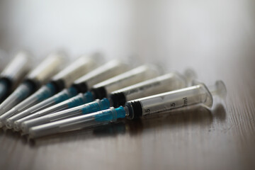 Fototapeta premium Medical Syringes in a Row on Wooden Surface Highlighting Healthcare and Vaccination