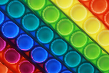 Vibrant Rainbow Pop It Fidget Toy Background Perfect for Stress Relief and Sensory Play