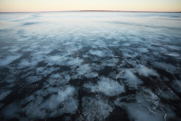 Frozen Lake Surface with Snow Patterns at Sunset - Winter Landscape and Nature Scene