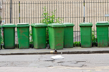 Naklejka premium Wheelie bins in row for refuge collection outdoors