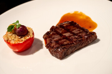Grilled Steak with Stuffed Tomato on Plate