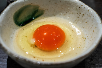 Raw Egg Yolk in Ceramic Bowl