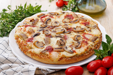 Mushroom pizza with sliced champignon and cheese on a white plate