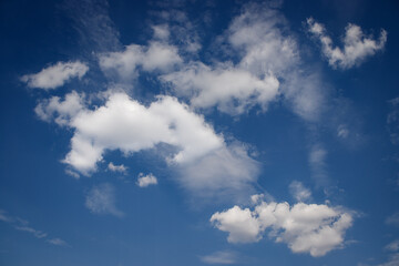 White clouds drifting across a deep blue sky