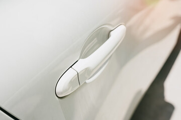 Close-Up View of Modern Vehicle Door Handle on a Sleek Car Exterior with Soft Lighting