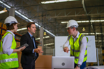 Blue collar workers are working and meeting at warehouse.