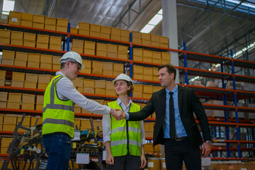 Blue collar workers are working and meeting at warehouse.