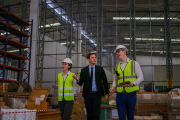 Blue collar workers are working and meeting at warehouse.