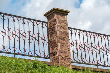 Decorative metal wrought iron fence .
