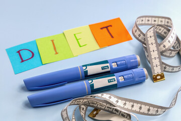 Ozempic pen for weight loss and diet abbreviation on multi-colored paper