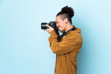 Photographer man over isolated blue background