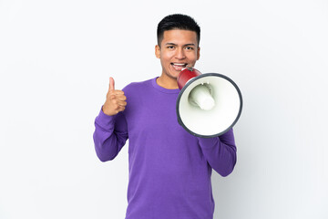 Young Ecuadorian man isolated on white background shouting through a megaphone to announce...