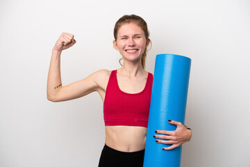 Young sport English woman going to yoga classes while holding a mat isolated on white background...