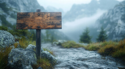 weathered wooden signpost on foggy mountain peak with swirling mist