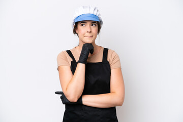 Fishmonger brazilian woman wearing an apron isolated on white background having doubts and thinking