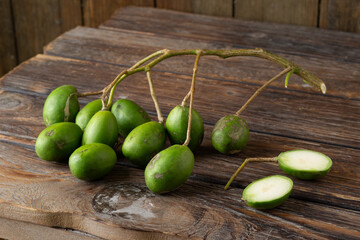 Fresh green kedondong fruits also known as ambarella arranged on a white background