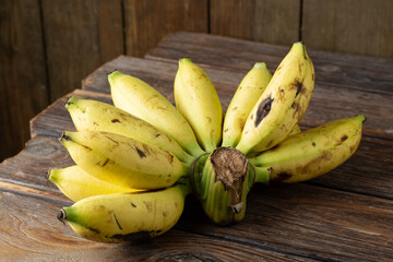 Fresh ripe Malaysian pisang emas bananas arranged in a bunch on a white background