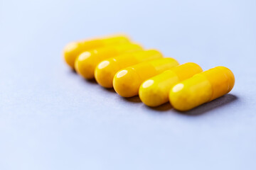 Vitamin C capsules. Bright background. Close up. Copy space.	