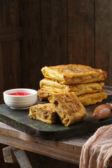 Close up of savory Malaysian murtabak filled with minced beef and chicken served as traditional street food on a plate