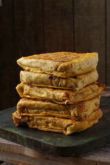 Close up of savory Malaysian murtabak filled with minced beef and chicken served as traditional street food on a plate