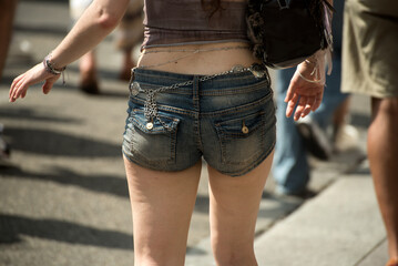 Closeup of mini jeans short on woman in the street