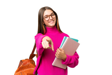 Teenager student caucasian girl over isolated background pointing front with happy expression