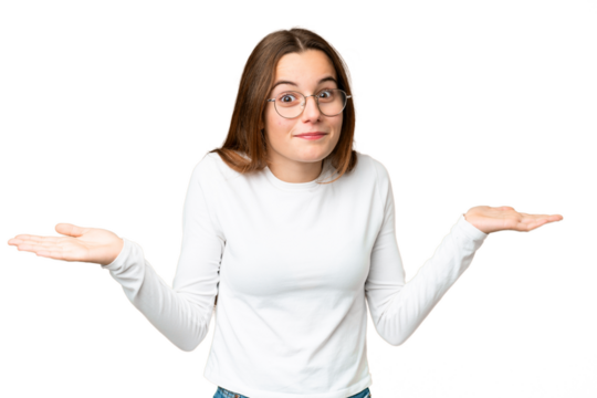 Teenager girl over isolated chroma key background having doubts while raising hands