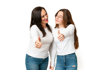 mother and daughter over isolated chroma key background giving a thumbs up gesture