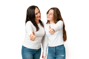 mother and daughter over isolated chroma key background giving a thumbs up gesture