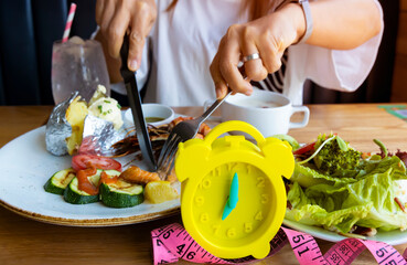 Alarm clock with IF (Intermittent Fasting) 16 and 8 diet rule and weight loss concept.-Diet plan concept