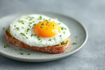 Close Up of Fried Egg and Avocado Toast on Gray Plate