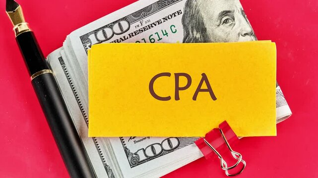 Animation of the appearance of the word CPA on yellow paper on top of dollar bills on a red background. Business concept. Certified public accountant (CPA). Finance concept