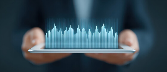 Digital tablet with holographic data chart, futuristic business technology concept showing financial analysis and growth